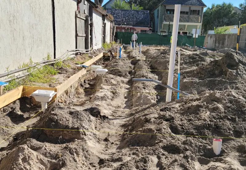 Plumber tools on wooden background top view.